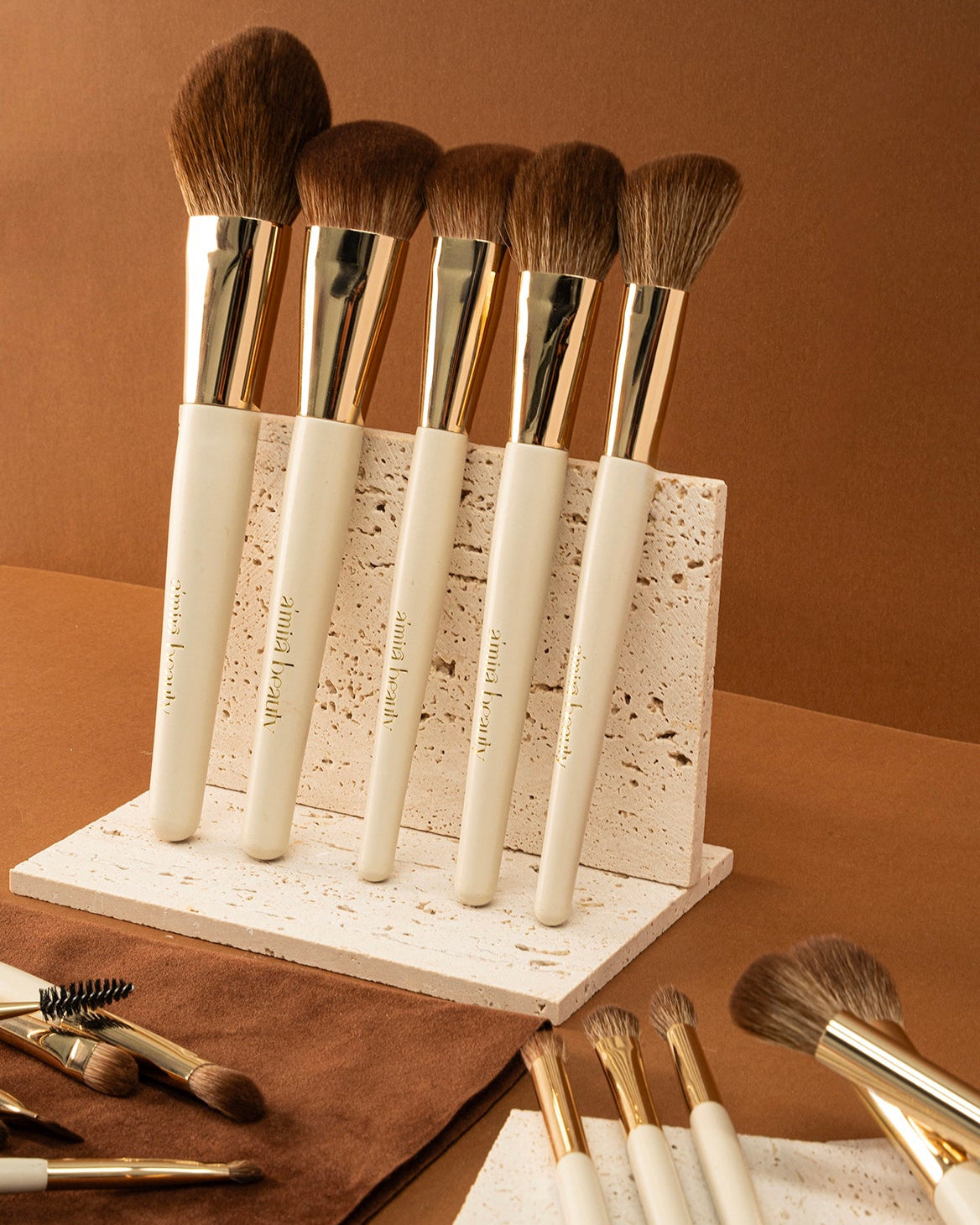 Set of makeup brushes on a stand against a brown background